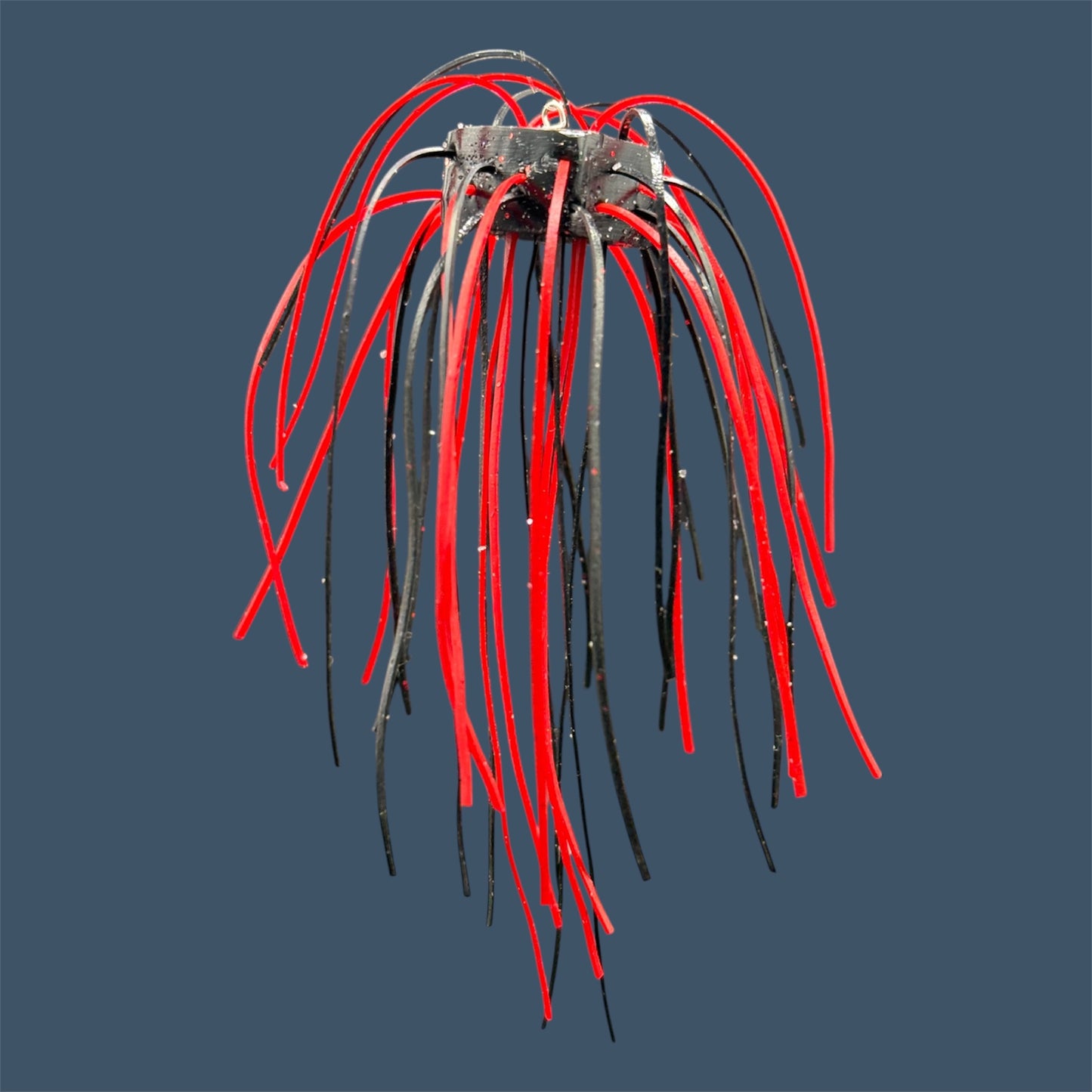 Skirted Cube Fuzzy Dice-style soft plastic bass lure, threaded with lifelike skirt material, perfect for drop shot and wacky rig finesse fishing.Shown in Black Cherry