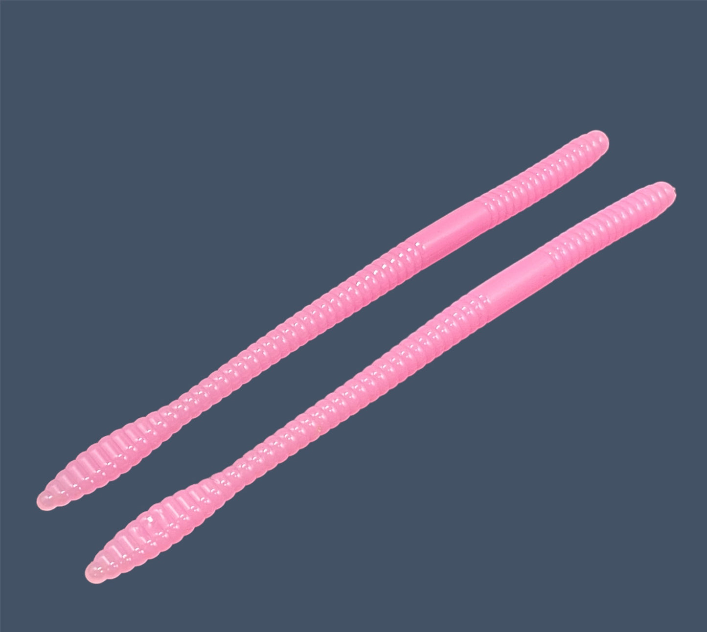 Soft Plastic Trick worm/Straight Tail Worm with flat spade-shaped tail and slender ribbed body. Spade Tail Worm shown in Bubblegum (Pink), a proven fish-catching color
