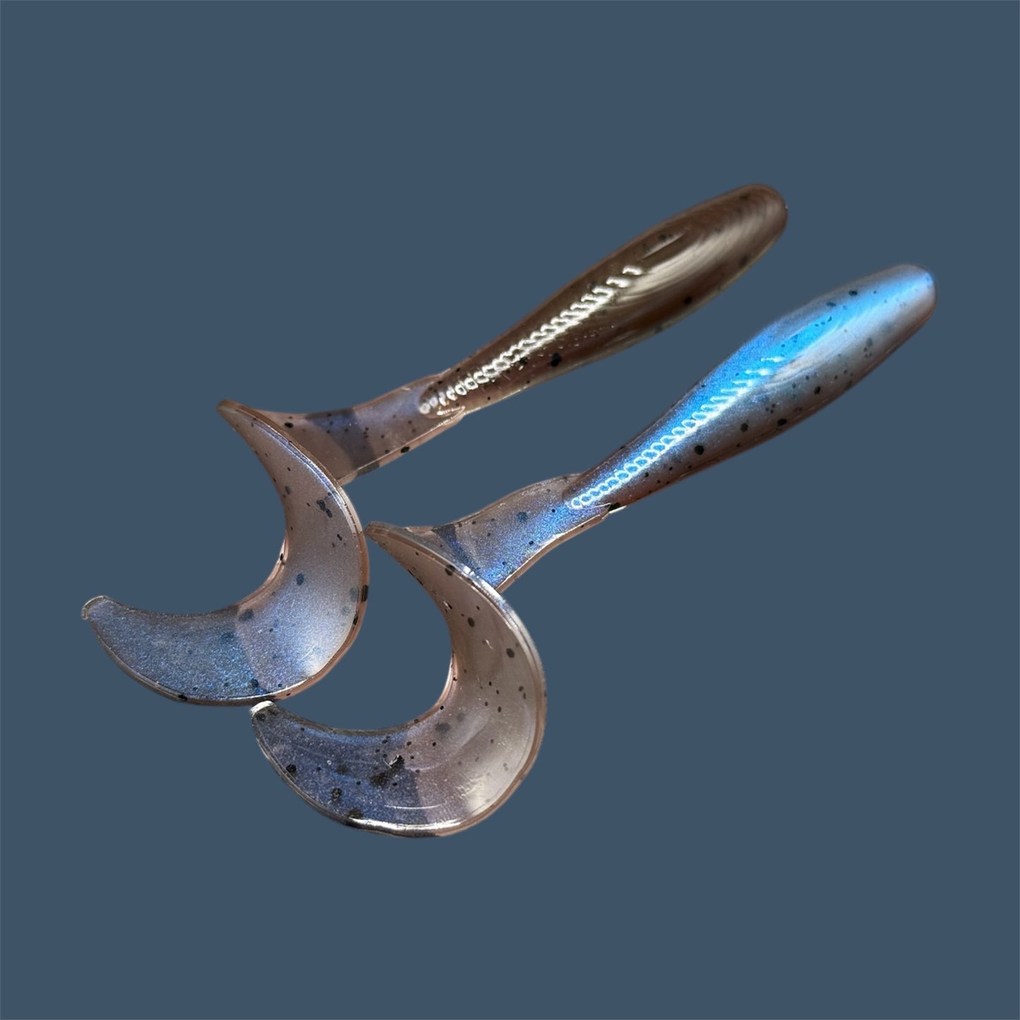 Single Tail Grub with a thick curl tail for strong water displacement, shown in Carolina Blues a proven fish-catching color suitable for both freshwater fishing and inshore saltwater fishing