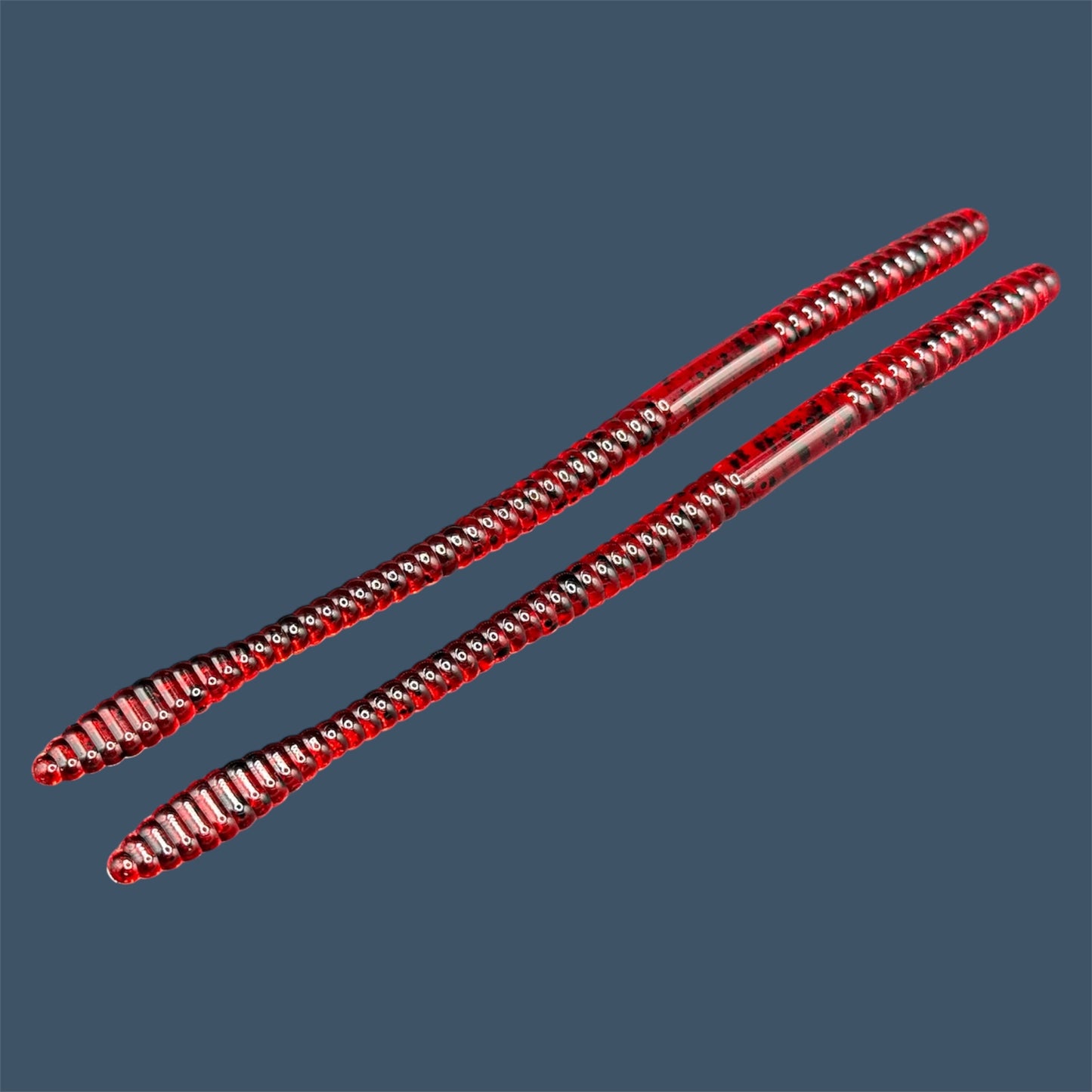 Soft Plastic Trick worm/Straight Tail Worm with flat spade-shaped tail and slender ribbed body. Spade Tail Worm in the color Cherry Seed, a proven fish-catching color