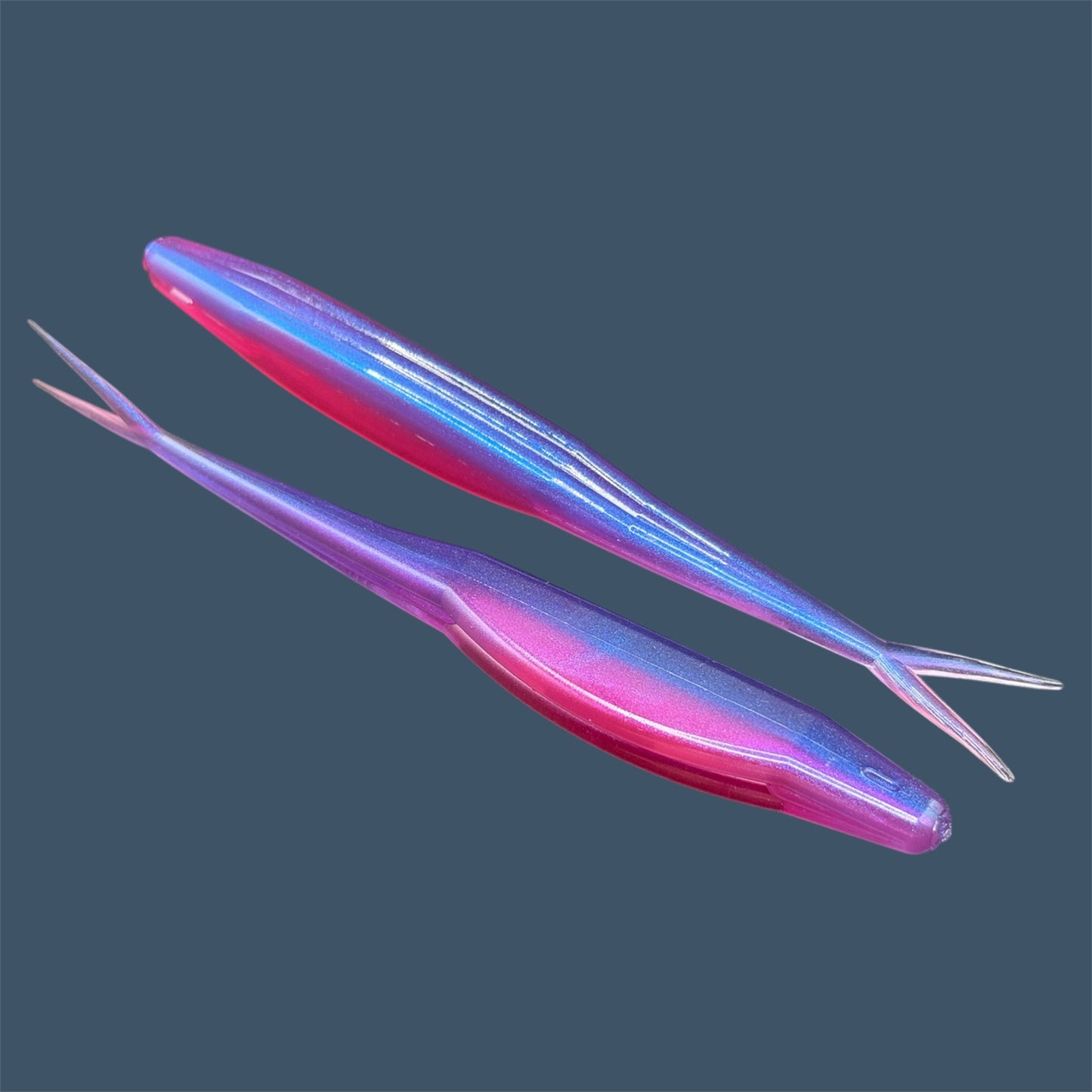 Split Tail Shad soft plastic Fluke style bait with realistic shad appearance, featuring a slotted belly for weedless rigging. Jerkbait in Daybreak Pearl (Pink and Purple) a proven fish-catching color