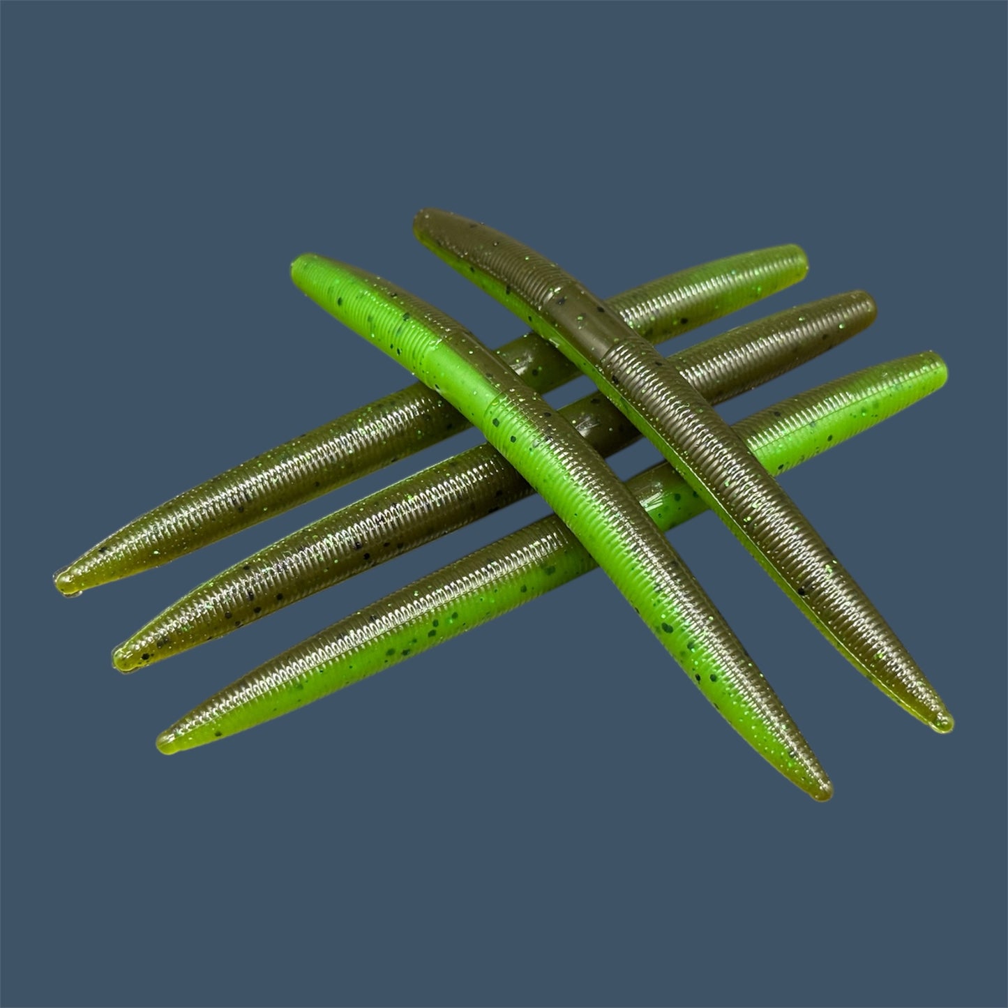 Boomstick is a senko-style stickbait for flipping, skipping, and casting, displayed in Envy (Green Pumpkin over Green) for different fishing conditions in freshwater fishing. Great addition to any anglers tackle box