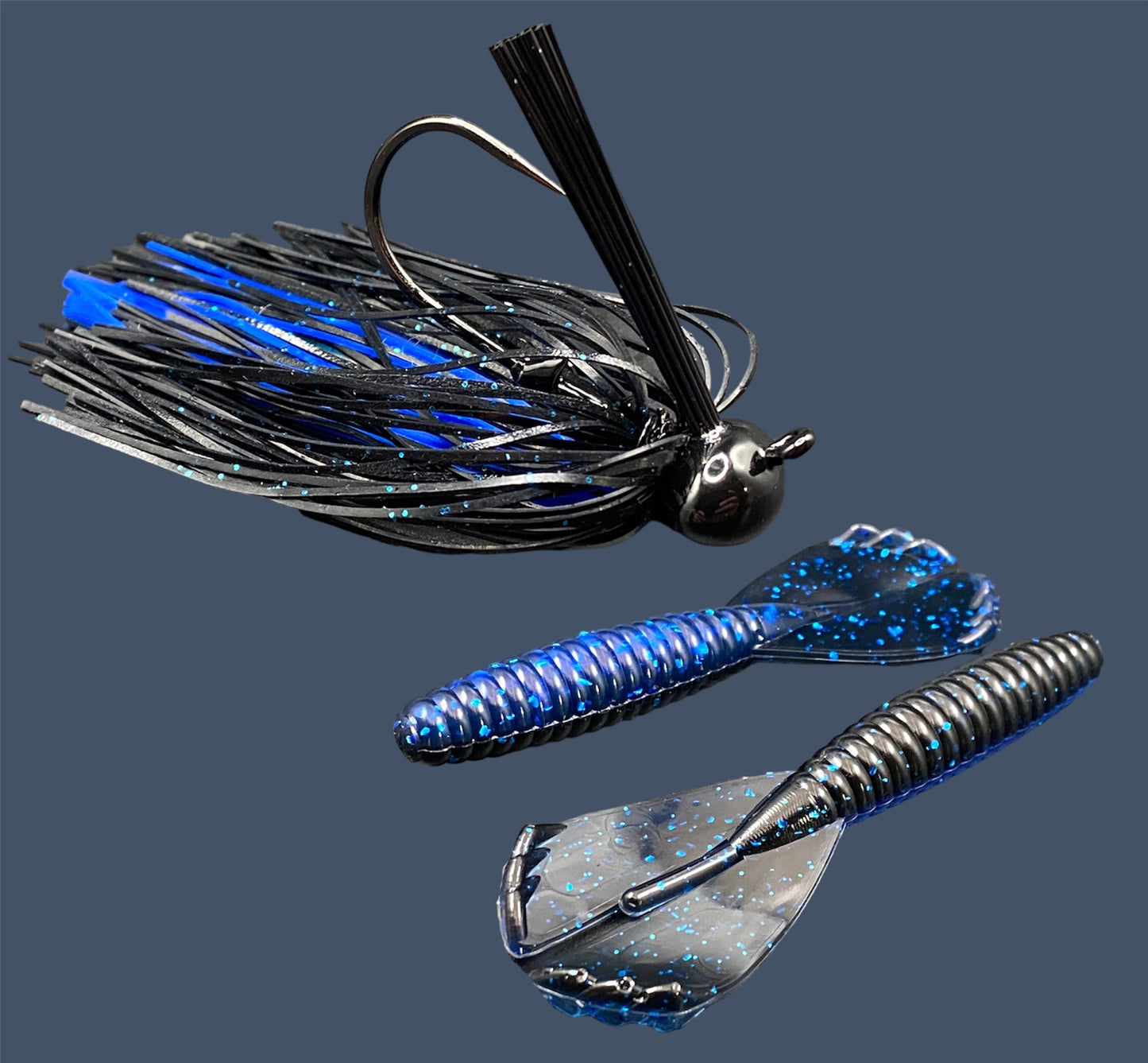 Fishing lure bundle with a high-quality jig and soft plastic bait, perfect for bass fishing with a variety of soft plastic lures. Shown here in color Black Sapphire (Black over blue flake) is a hand tied black football jig paired with Big League Bait Grub 3.5"