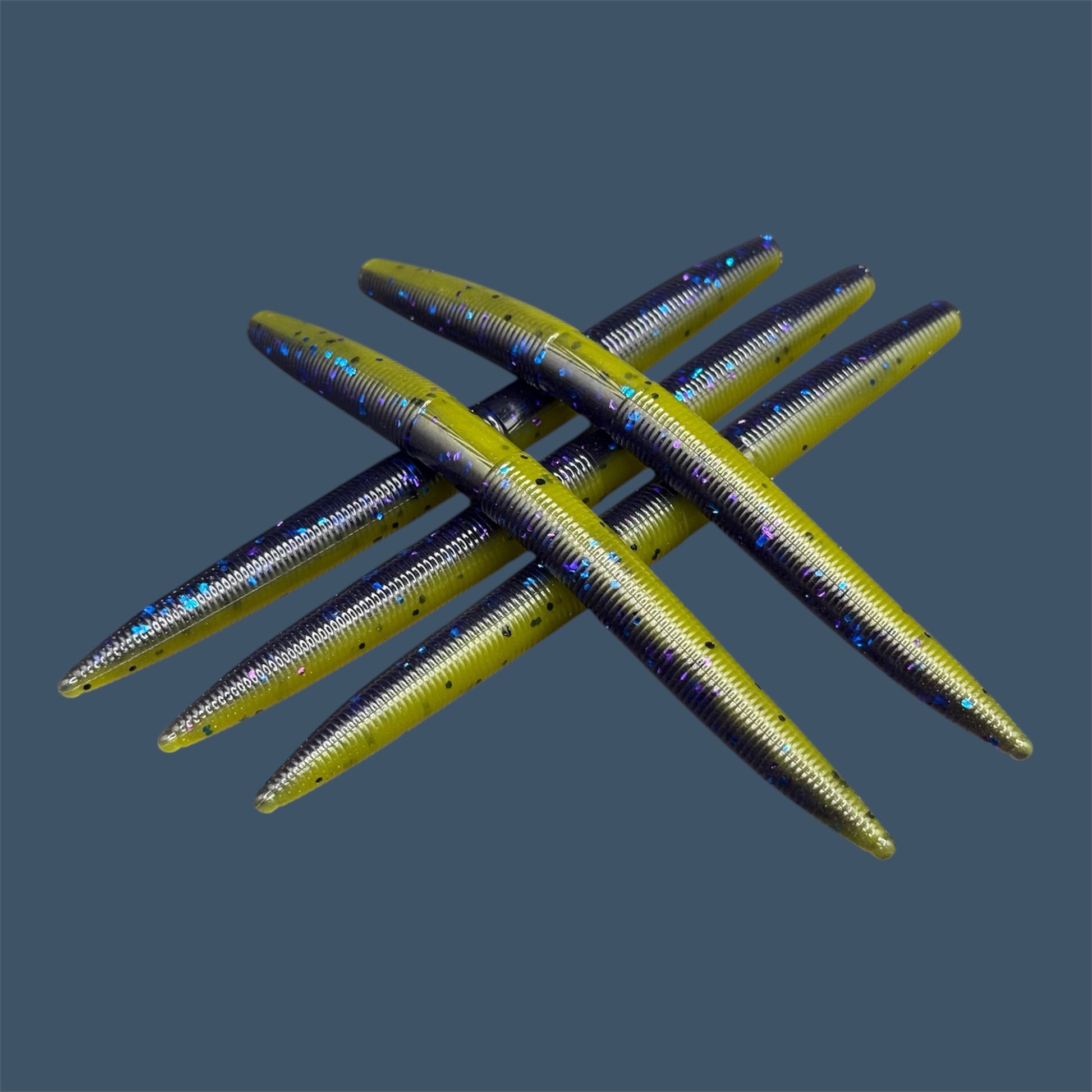 Boomstick is a senko-style  for flipping, skipping, and casting, displayed in Luau  (Purple over Banana Seed) for different fishing conditions in freshwater fishing. Great addition to any anglers tackle box