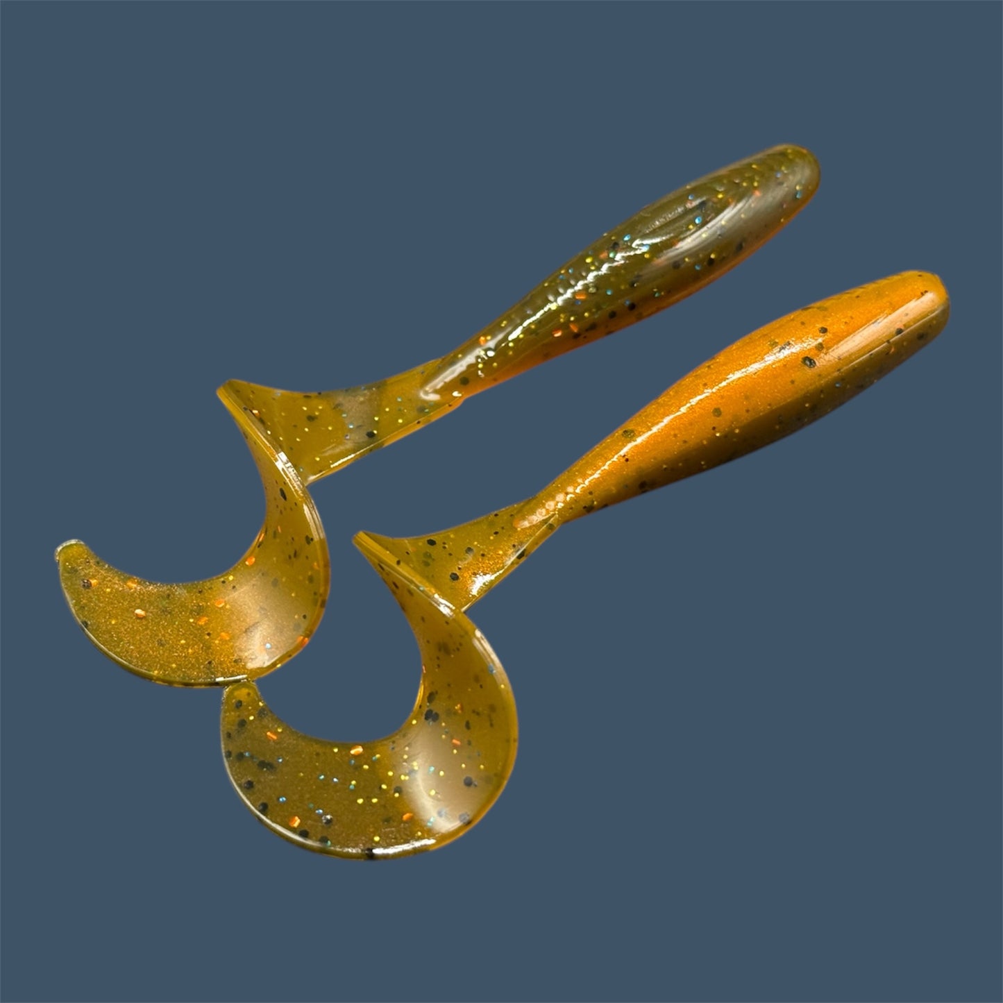 Single Tail Grub with a thick curl tail for strong water displacement, shown in Pumpkin Spice a proven fish-catching color suitable for both freshwater fishing and inshore saltwater fishing