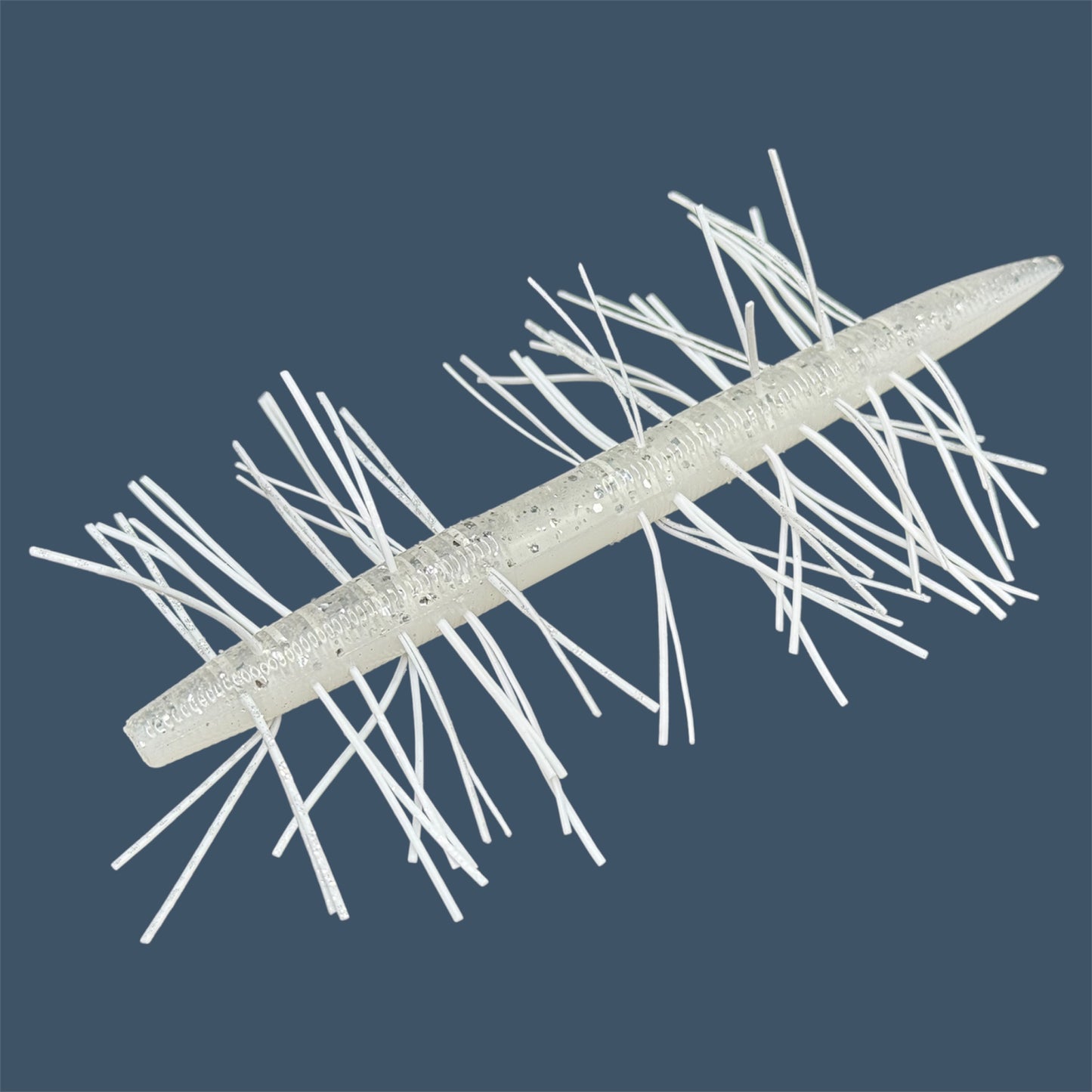 Skirted Boomstick Soft Plastic Bait (Stick worm style bait) with embedded skirt material for Fishing. Shown in White Ice Fuzzy Soft Plastic Lure