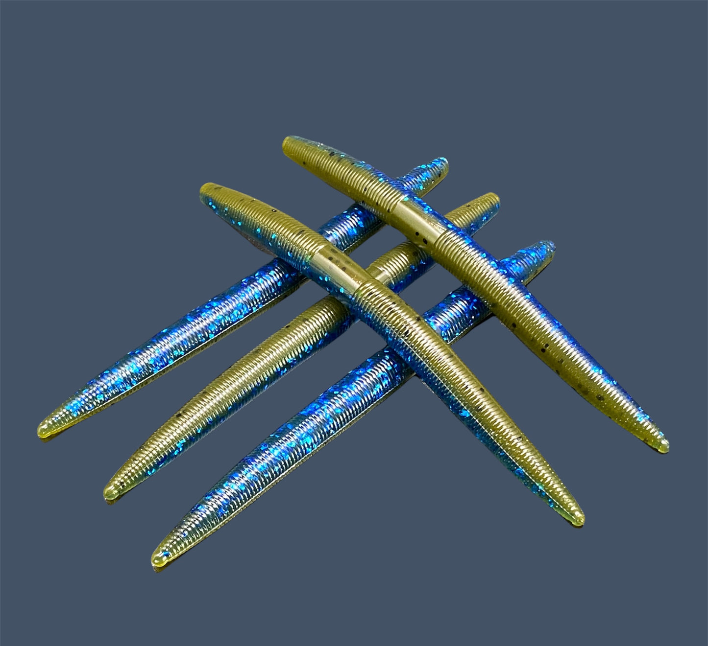 Boomstick is a senko-style stickbait for flipping, skipping, and casting, displayed in Big "O" (Green Pumpkin with Blue Flake) for different fishing conditions in freshwater fishing. Great addition to any anglers tackle box