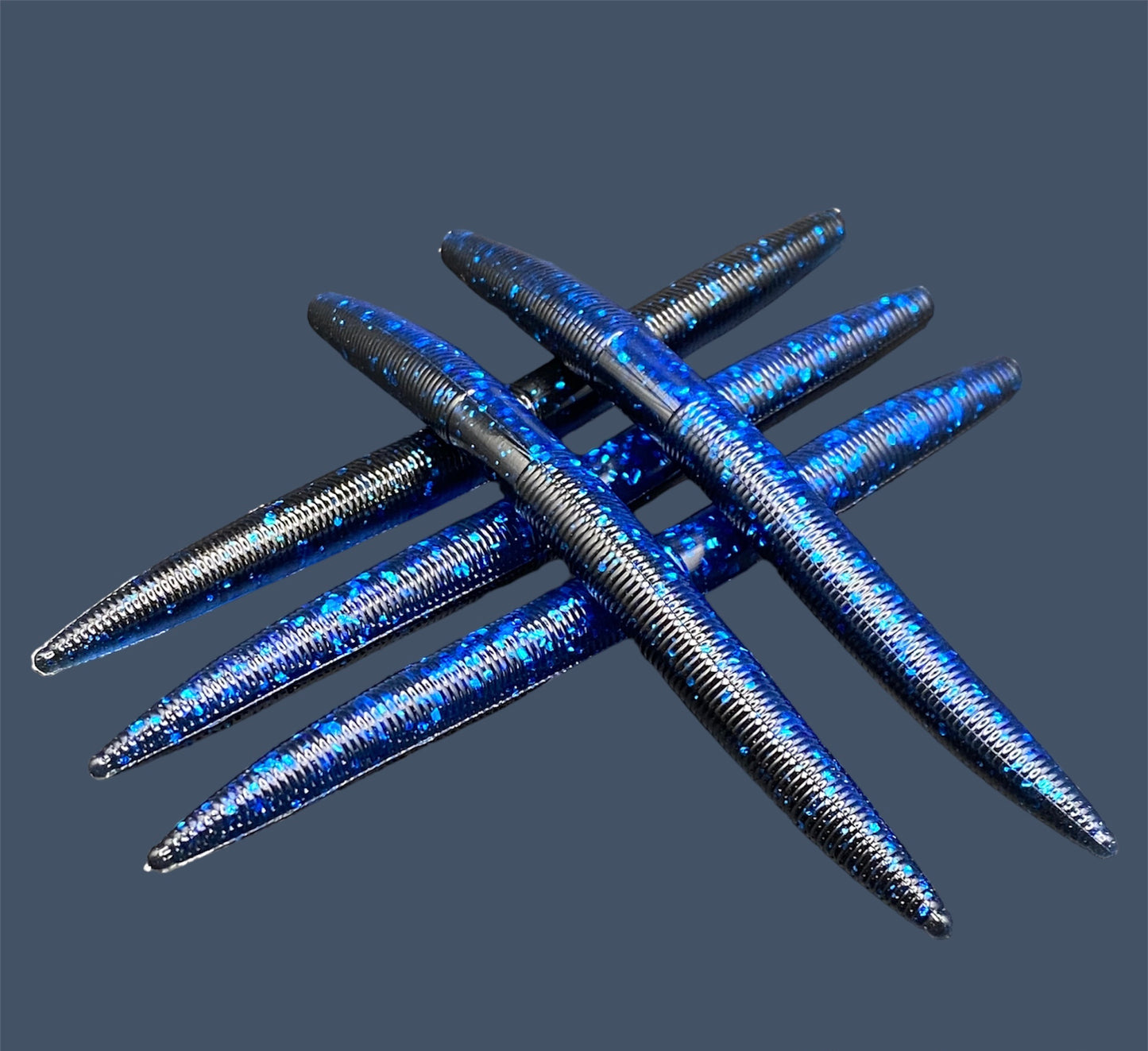 Boomstick is a senko-style stickbait for flipping, skipping, and casting, displayed in Black Sapphire (Black and Blue) for different fishing conditions in freshwater fishing. Great addition to any anglers tackle box