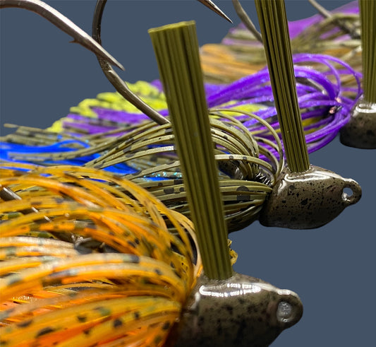 Collection of Flipping Jigs in various proven fish-catching patterns and colors, showcasing their aggressive angled heads, Mustad Hook and fiber weed guards for effective fishing in diverse conditions.