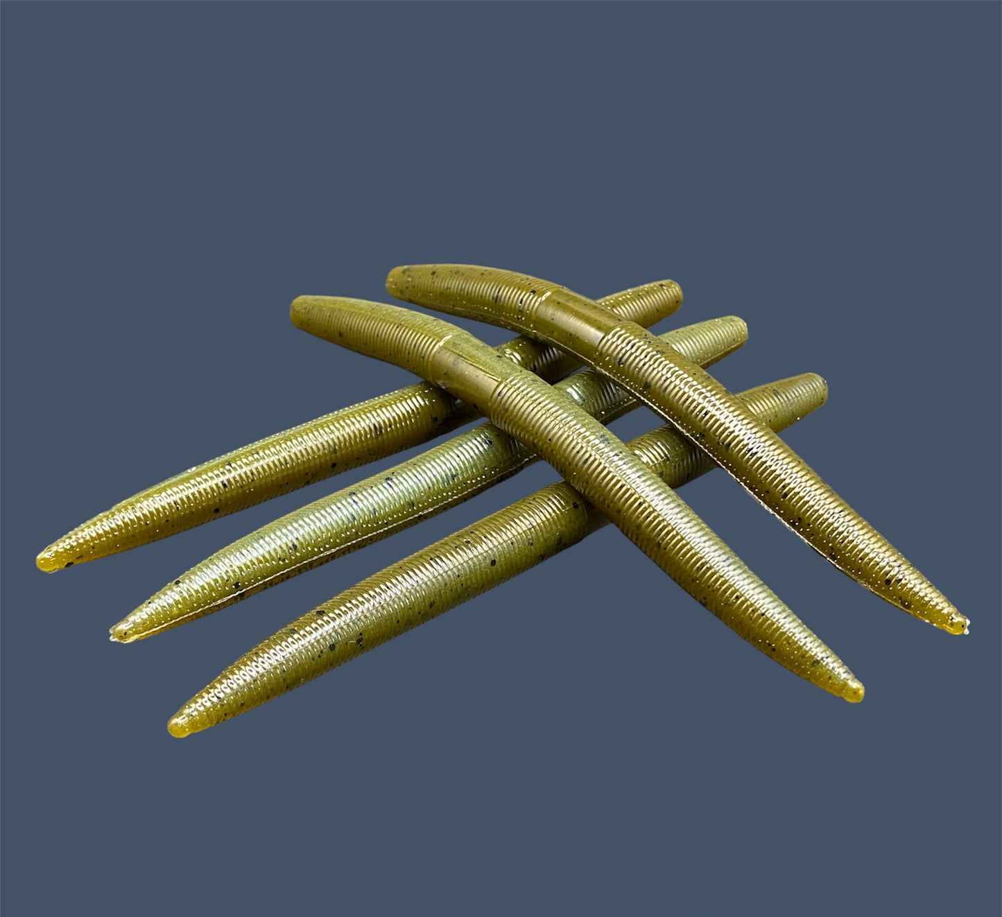 Boomstick is a senko-style stickbait for flipping, skipping, and casting, displayed in Magic Craw (Green Pumpkin) for different fishing conditions in freshwater fishing. Great addition to any anglers tackle box