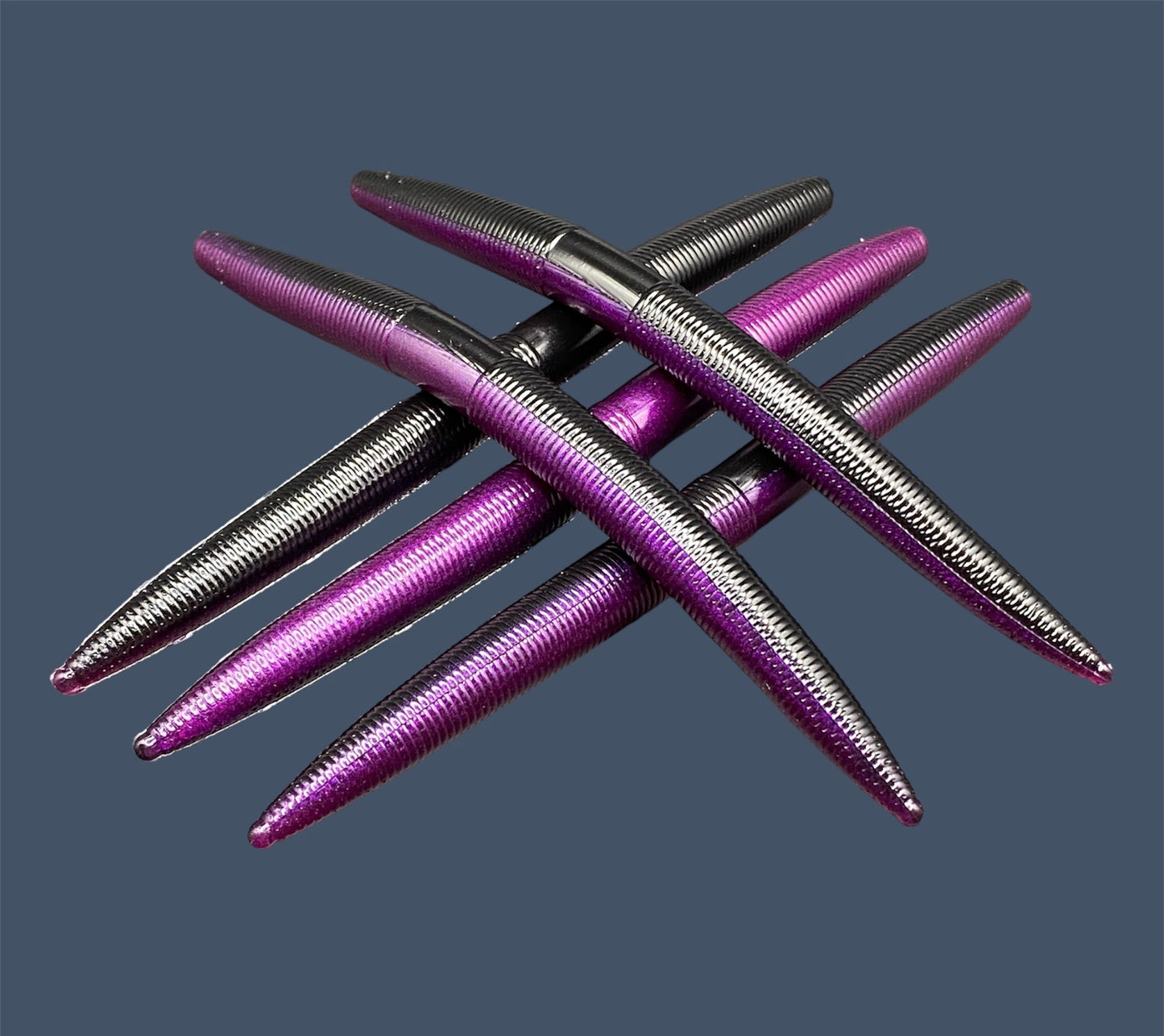 Boomstick is a senko-style stickbait for flipping, skipping, and casting, displayed in Midnight Purple (Black and Purple) for different fishing conditions in freshwater fishing. Great addition to any anglers tackle box