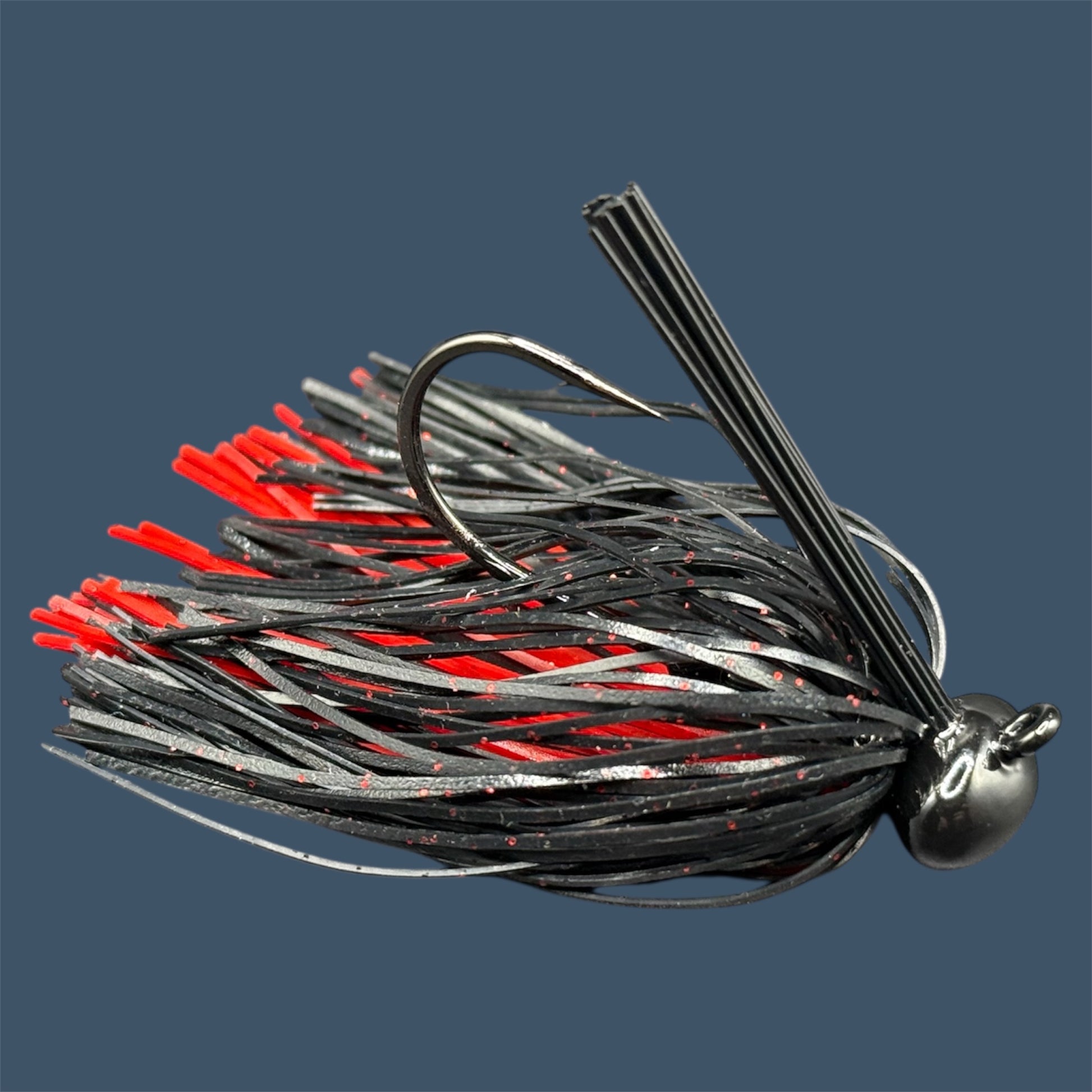 Football Jigs in Black and Blue, highlighting the robust Mustad Heavy Wire hooks, integrated plastics keepers, and flaring 100% silicone skirts.