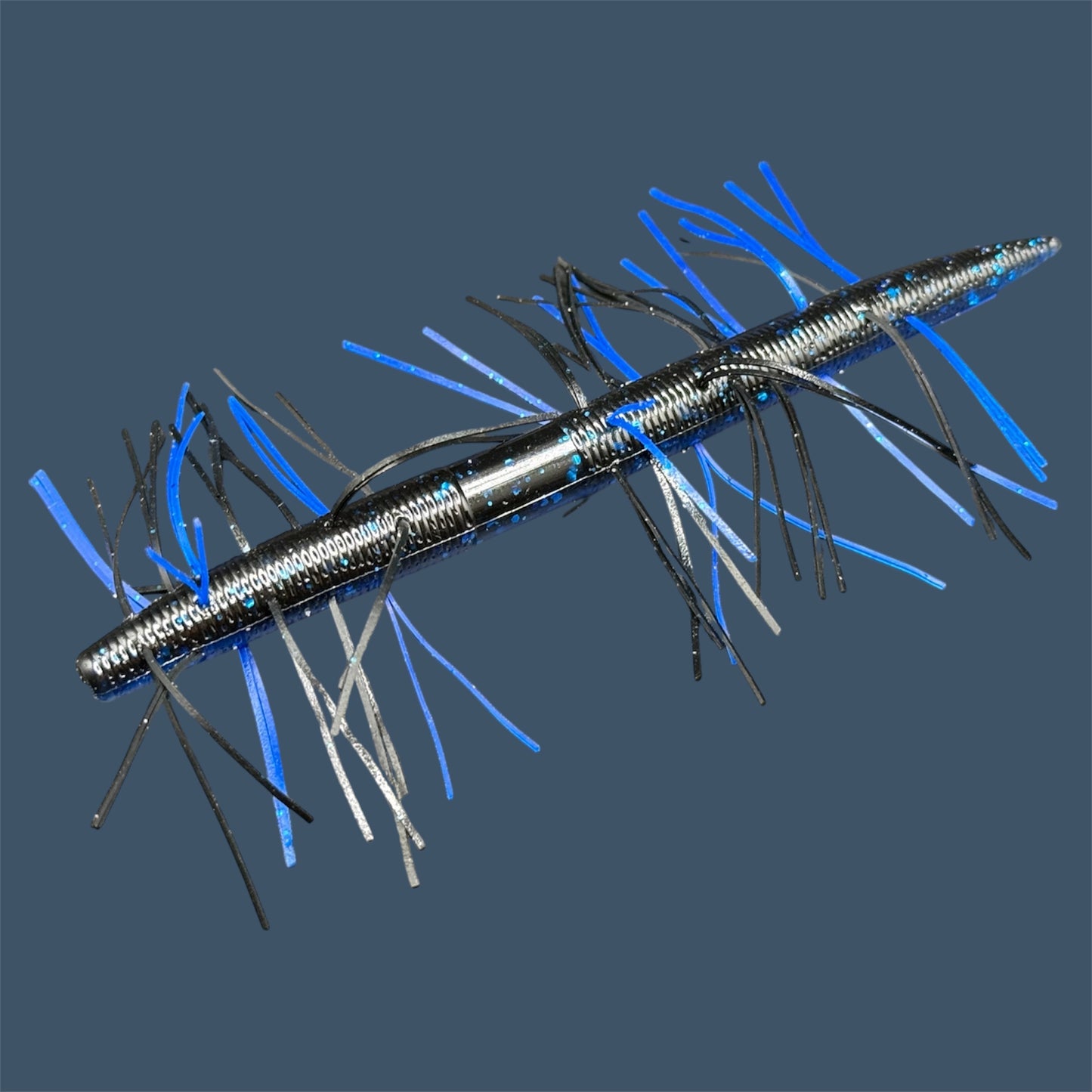 Fuzzy Boomstick Soft Plastic Bait (Stick worm style bait) with embedded skirt material for Fishing. Shown in Black Sapphire (Black and Blue) Fuzzy Soft Plastic Lure