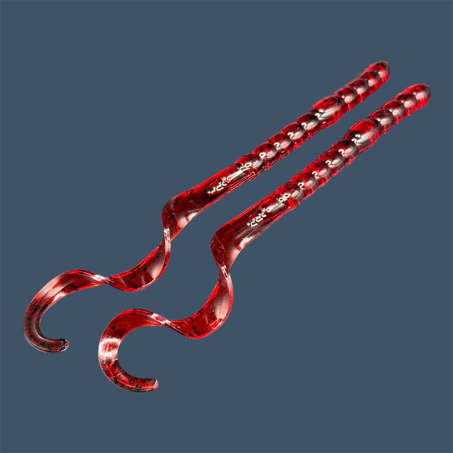 Soft plastic curly/ribbon tail worm 7.5-inch with realistic movement and versatile design for Texas and Carolina rigs. 7.5" Curl Tail Worm shown in Cherry Seed
