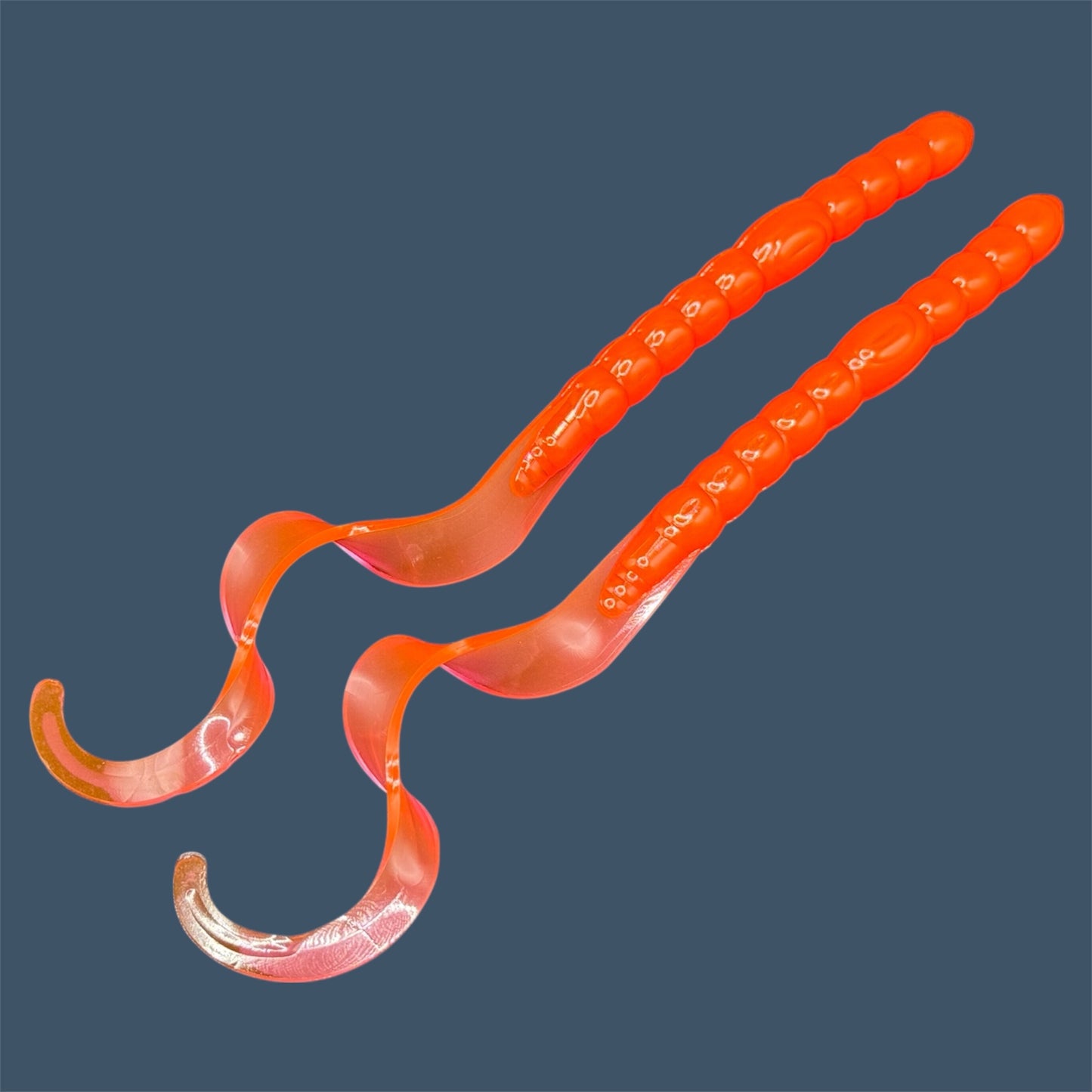 Soft plastic curly/ribbon tail worm 7.5-inch with realistic movement and versatile design for Texas and Carolina rigs. 7.5" Curl Tail Worm shown in Merthiolate