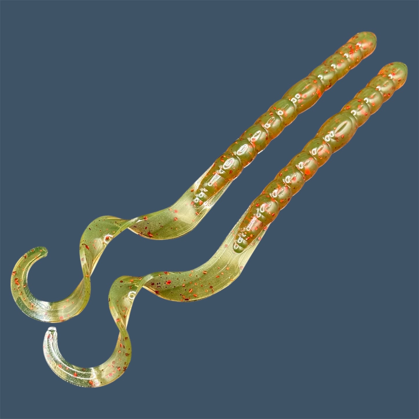 Soft plastic curly/ribbon tail worm 7.5-inch with realistic movement and versatile design for Texas and Carolina rigs. 7.5" Curl Tail Worm shown in Motor Oil Red