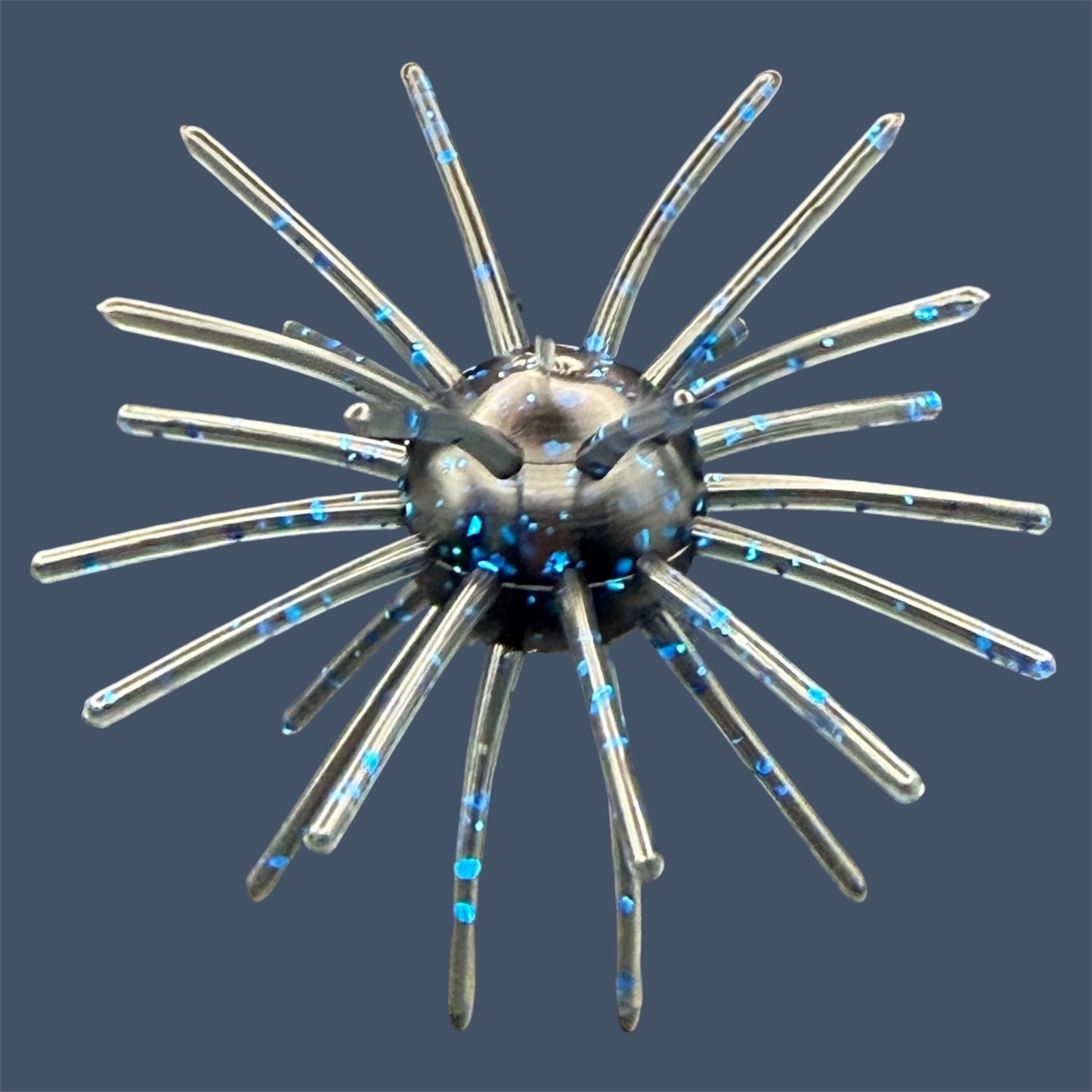 Oddball 2.5-inch urchin style bass fishing bait with 28 appendages. Shown in color Black & Blue