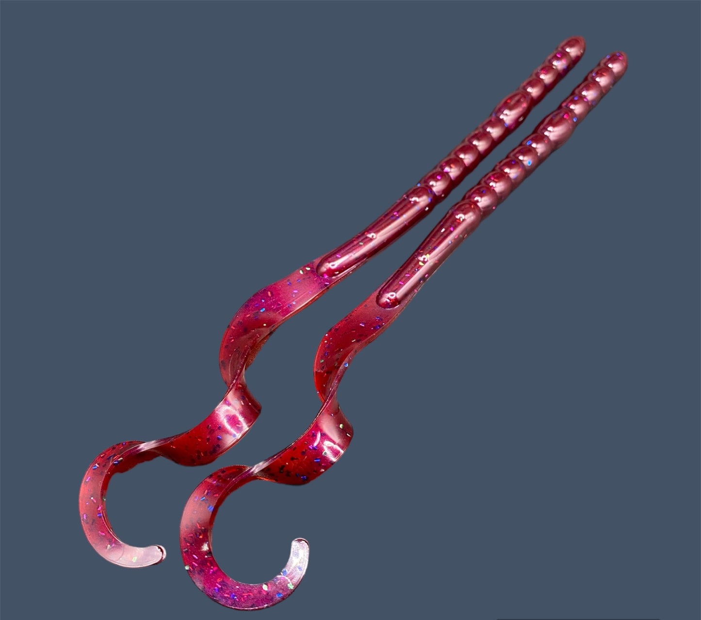 Large Curl Tail Worm 10" with a realistic curl tail, ideal for Texas and Carolina rigging, available in Plum Silly (Red)