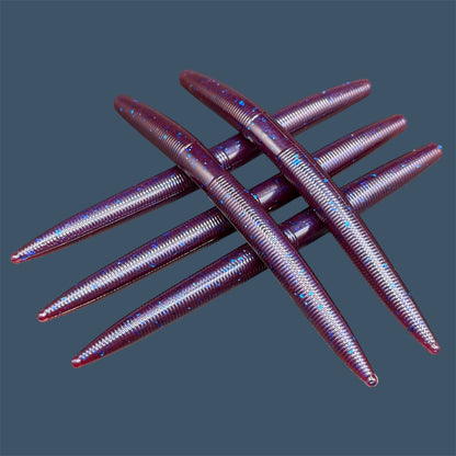 Boomstick is a senko-style stickbait for flipping, skipping, and casting, displayed in Plum Pearl for different fishing conditions in freshwater fishing. Great addition to any anglers tackle box