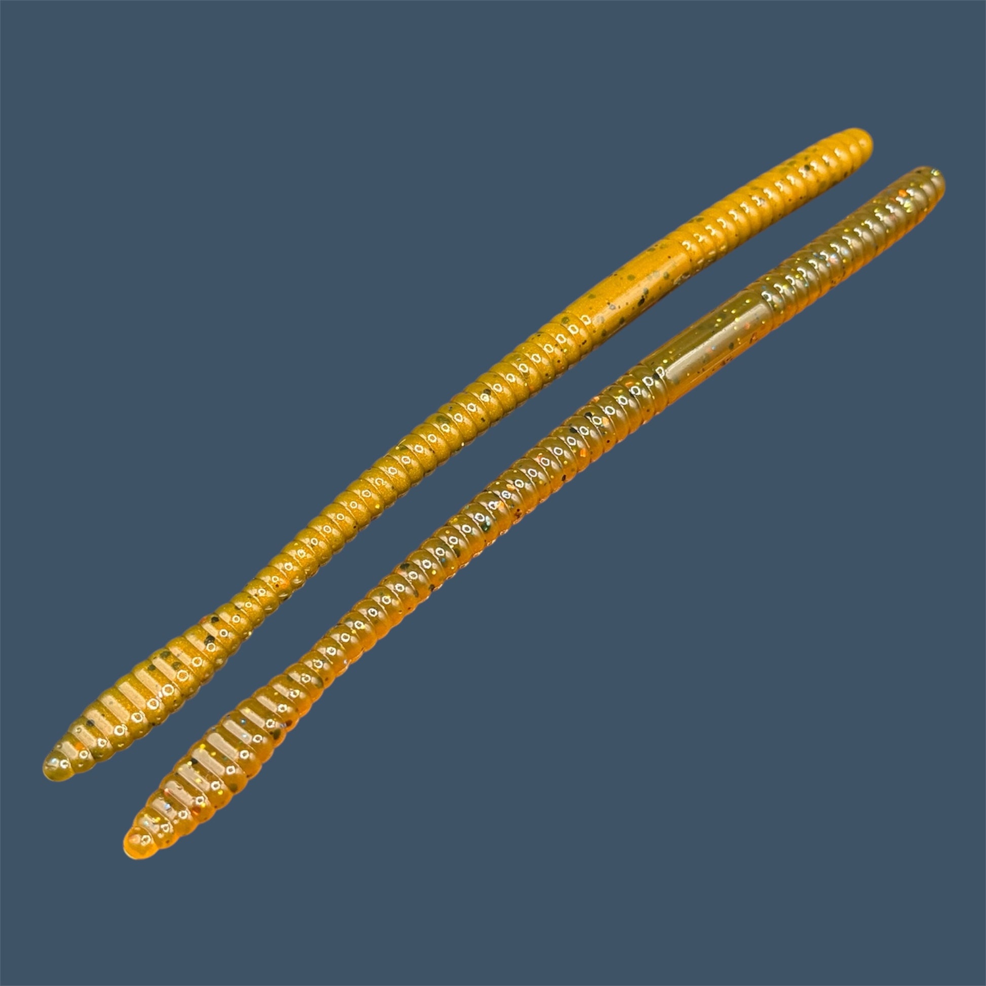 Soft Plastic Trick worm or Straight Tail Worm with flat spade-shaped tail and slender ribbed body. Spade Tail Worm shown in Pumpkin Spice, a proven fish-catching color