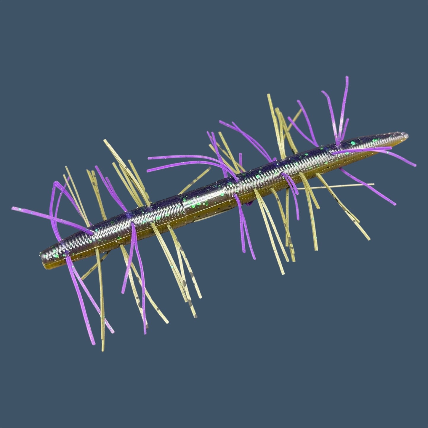 Fuzzy Boomstick Soft Plastic Bait (Stick worm style bait) with embedded skirt material for Fishing. Shown in Swamp Juice (Purple and Green Pumpkin) Fuzzy Soft Plastic Lure