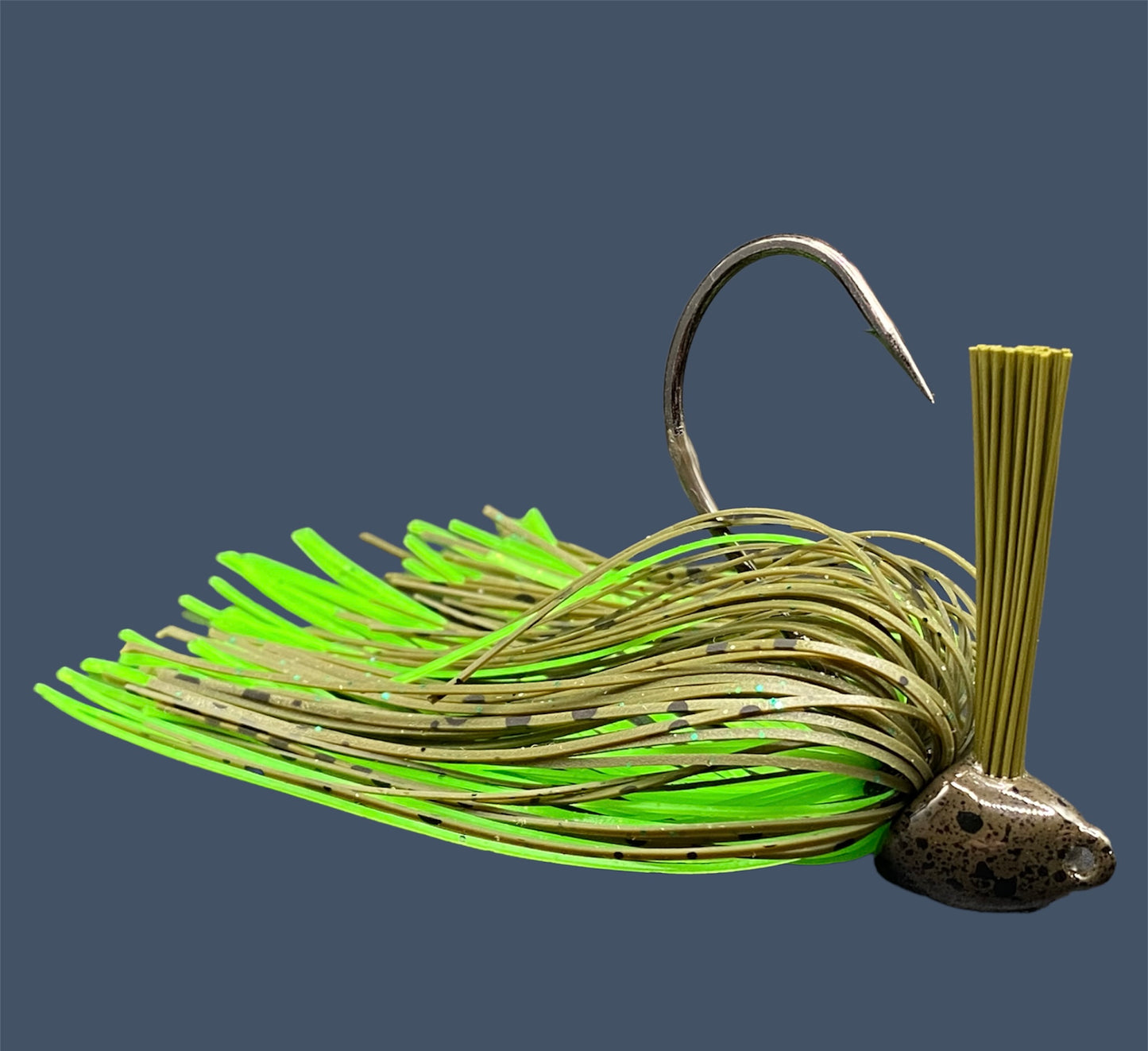 Flipping Jig in Envy (Green Pumpkin), showcasing the aggressive angled heads, Mustad Hook and fiber weed guards for effective fishing in diverse conditions.