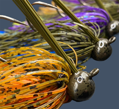 Selection of Football Jigs in various fish-catching colors and patterns, highlighting their robust Mustad Heavy Wire hooks, integrated plastics keepers, and flaring 100% silicone skirts.